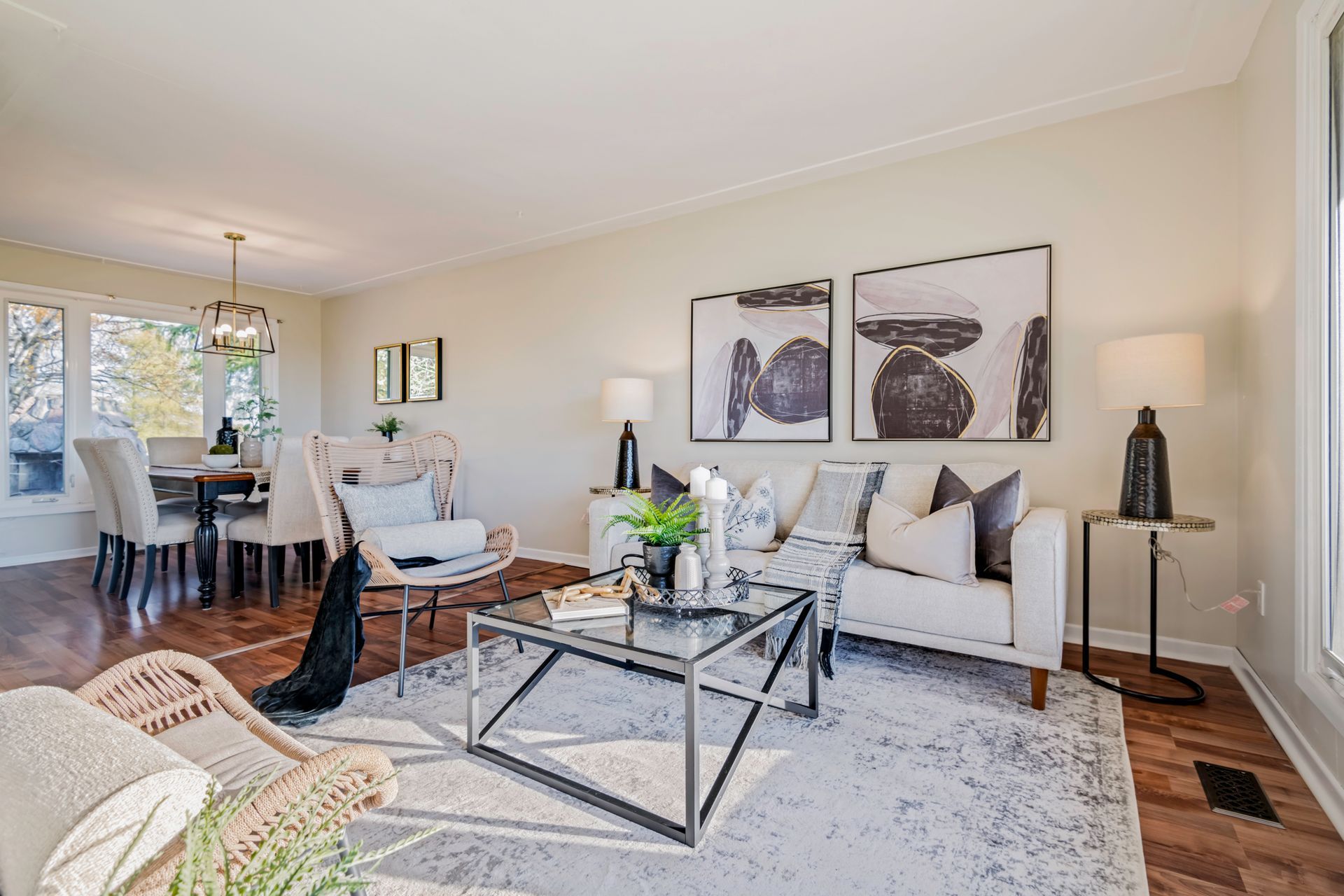 A living room with a couch , table , chairs and a rug.