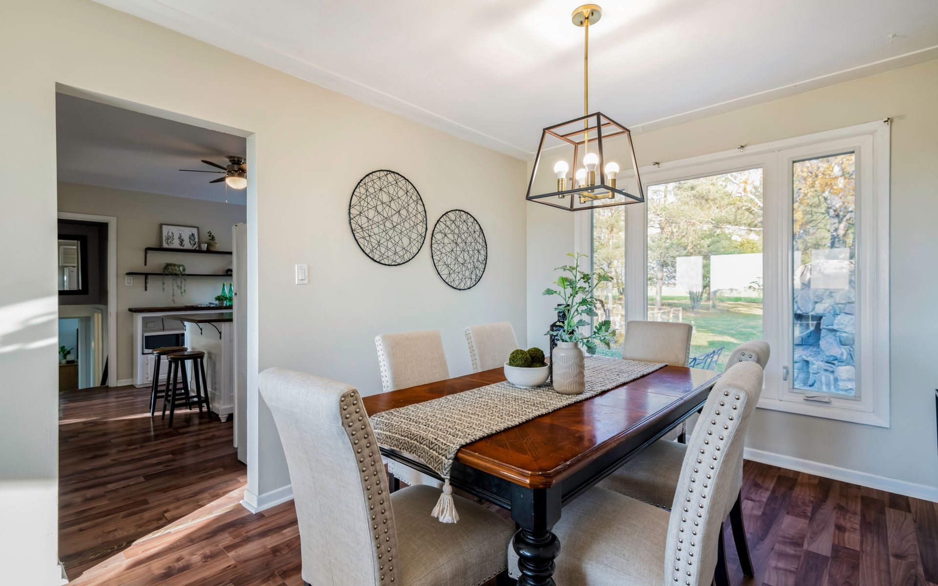 A dining room with a table and chairs and a chandelier.
