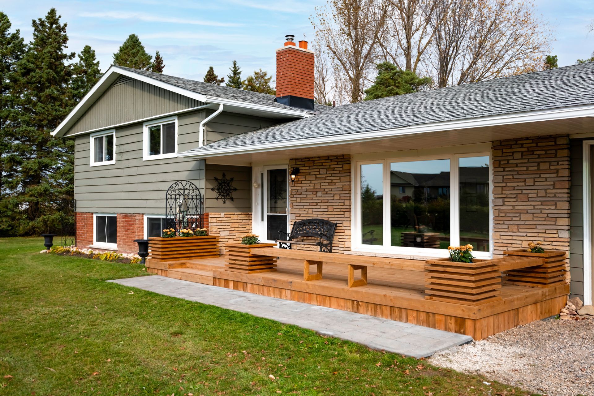 A large house with a large deck in front of it.