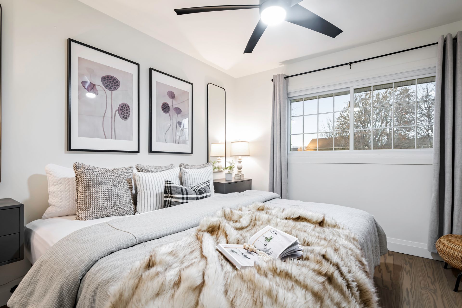 A bedroom with two beds and a ceiling fan.