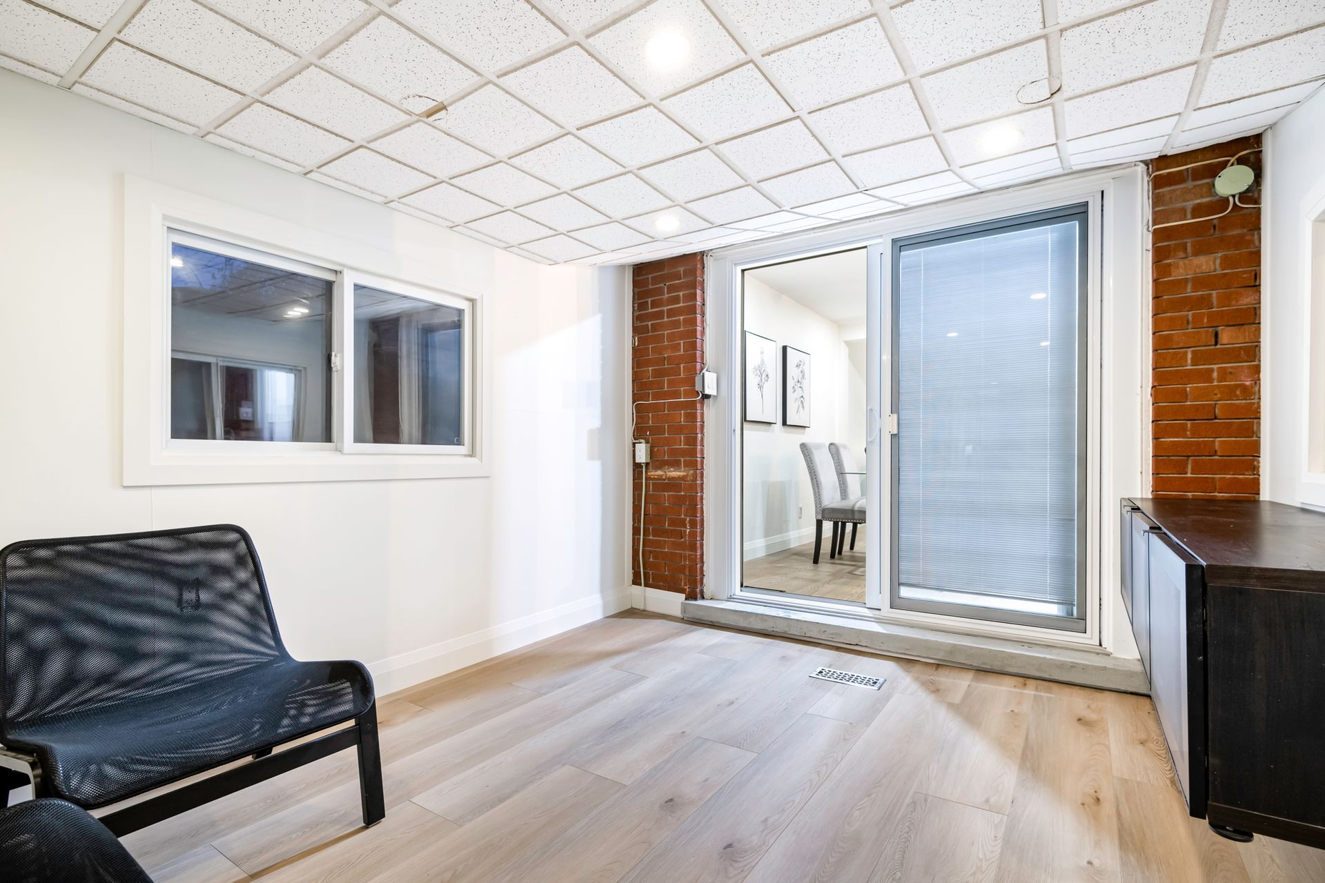 A living room with two chairs and a sliding glass door.