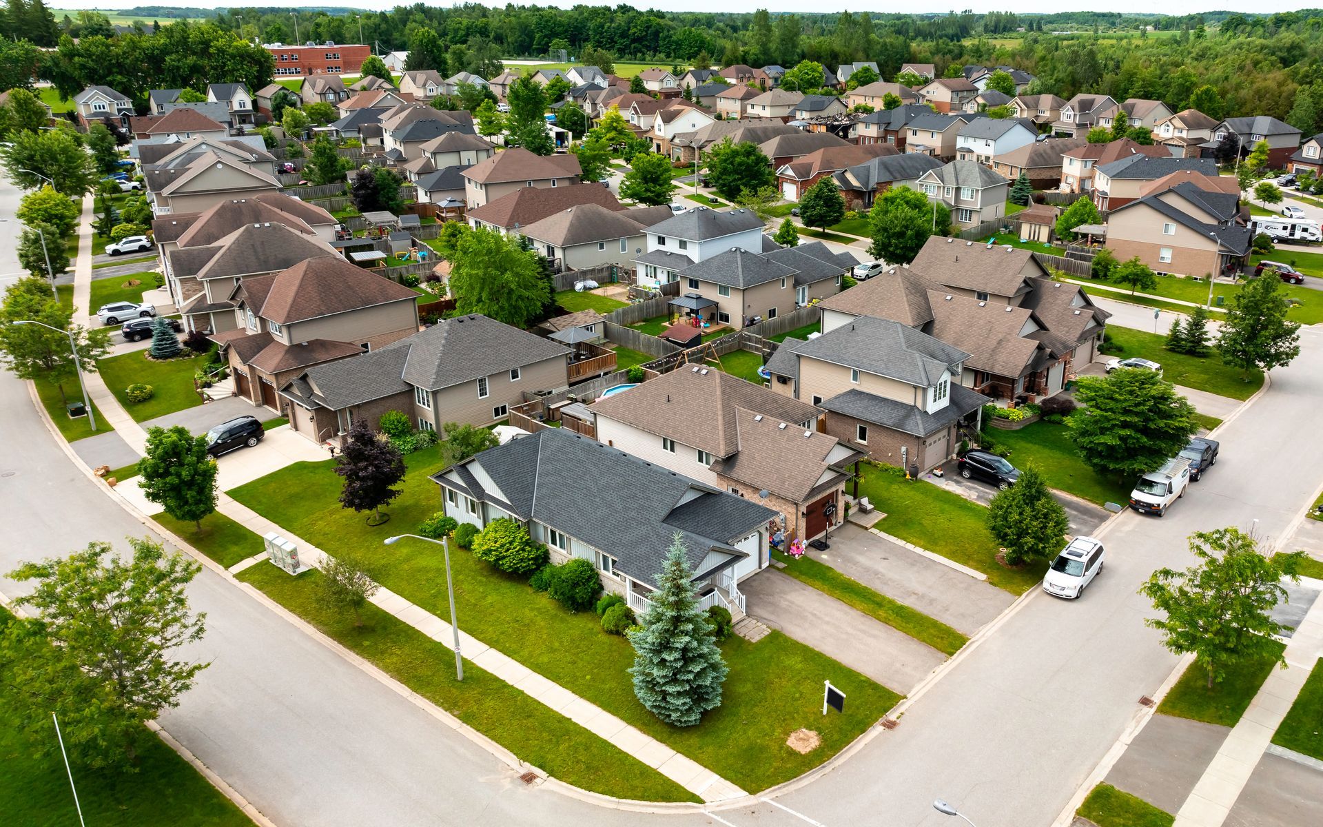 An aerial view of a residential neighborhood with lots of houses and trees.
