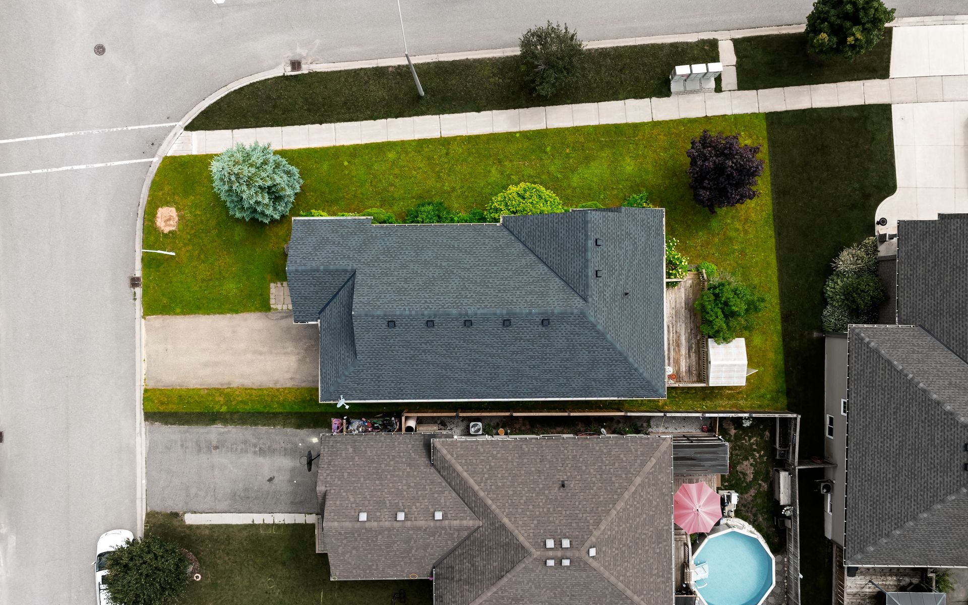 An aerial view of a house with a pool in the backyard.