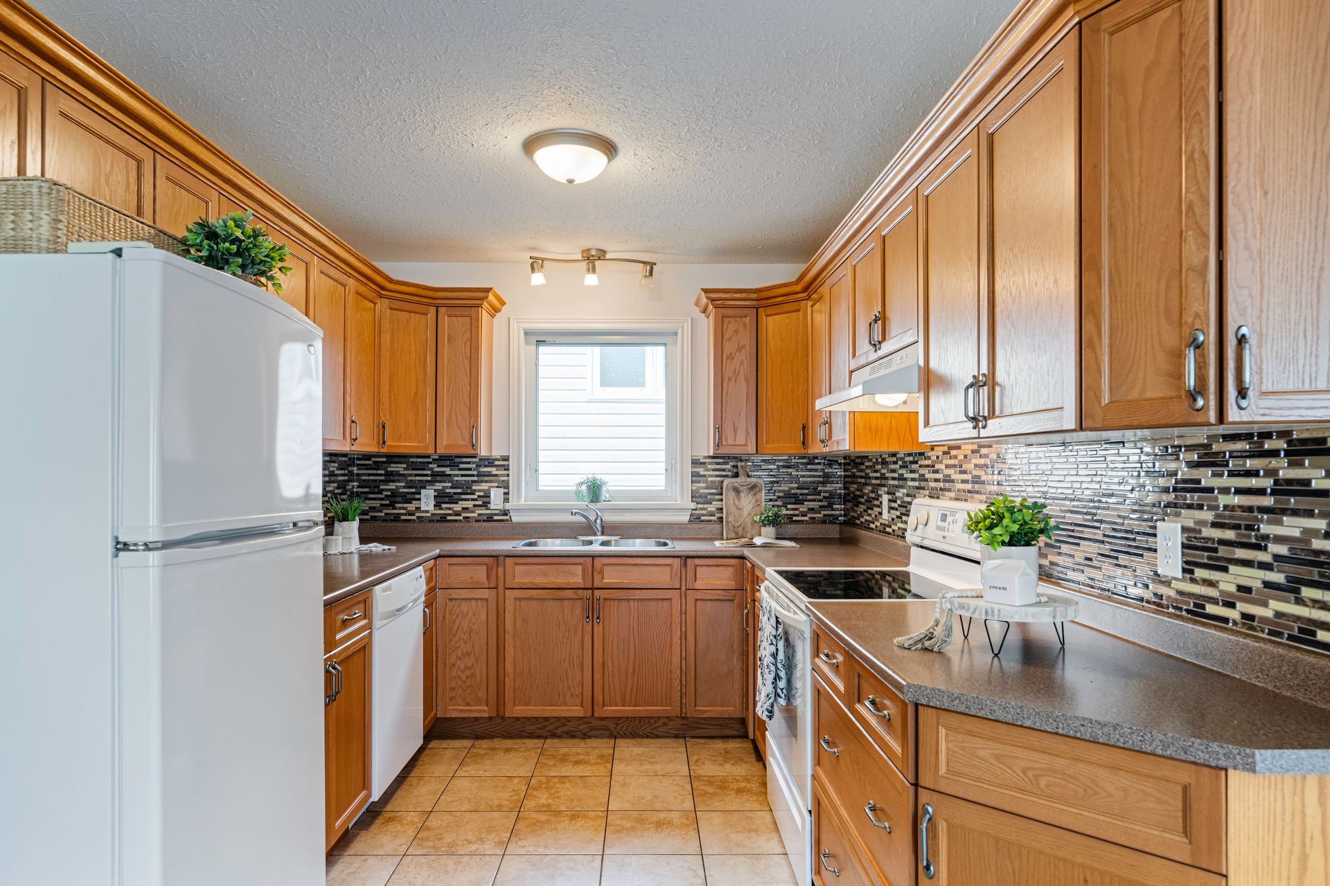 A kitchen with wooden cabinets and a white refrigerator.
