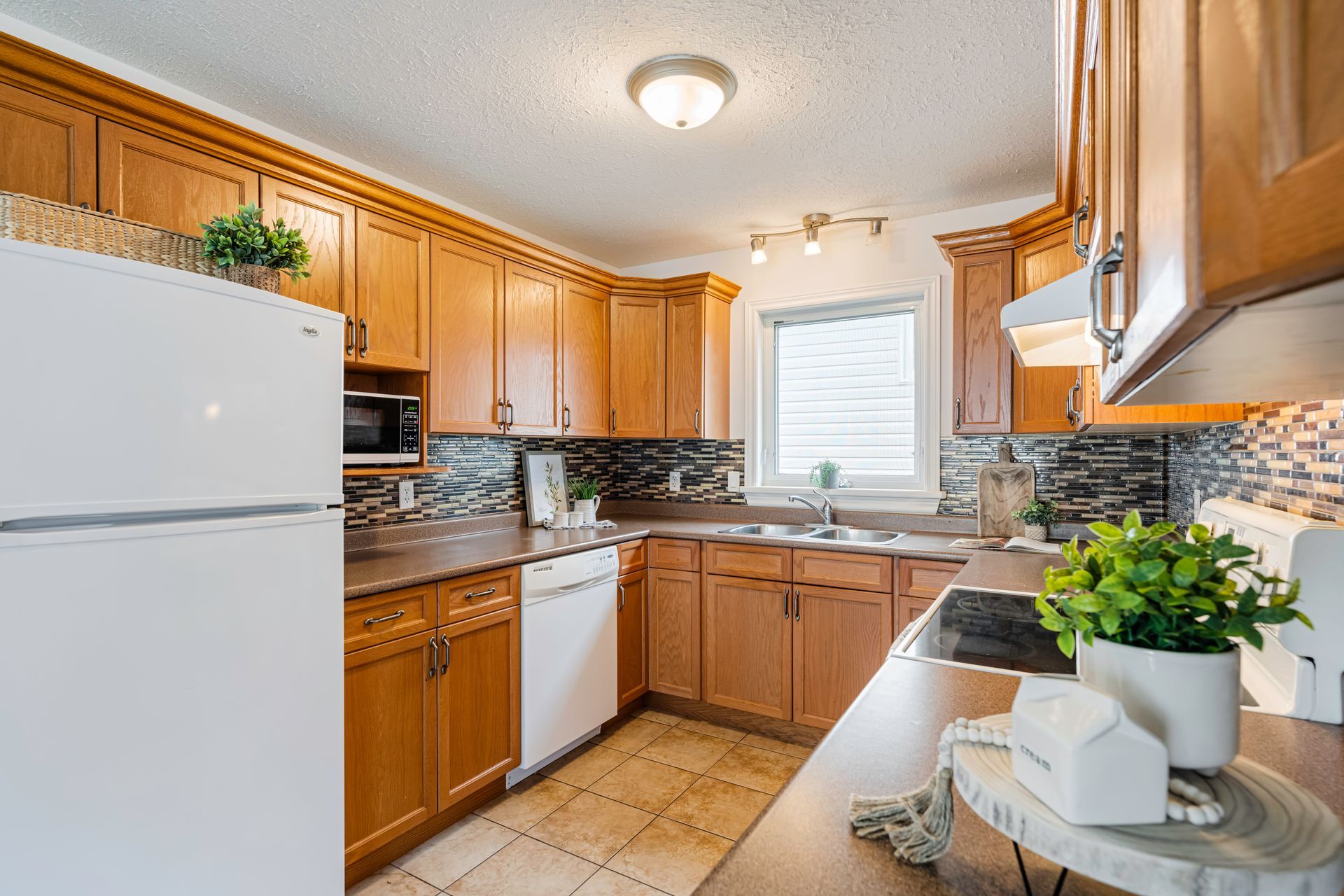A kitchen with wooden cabinets and a white refrigerator.