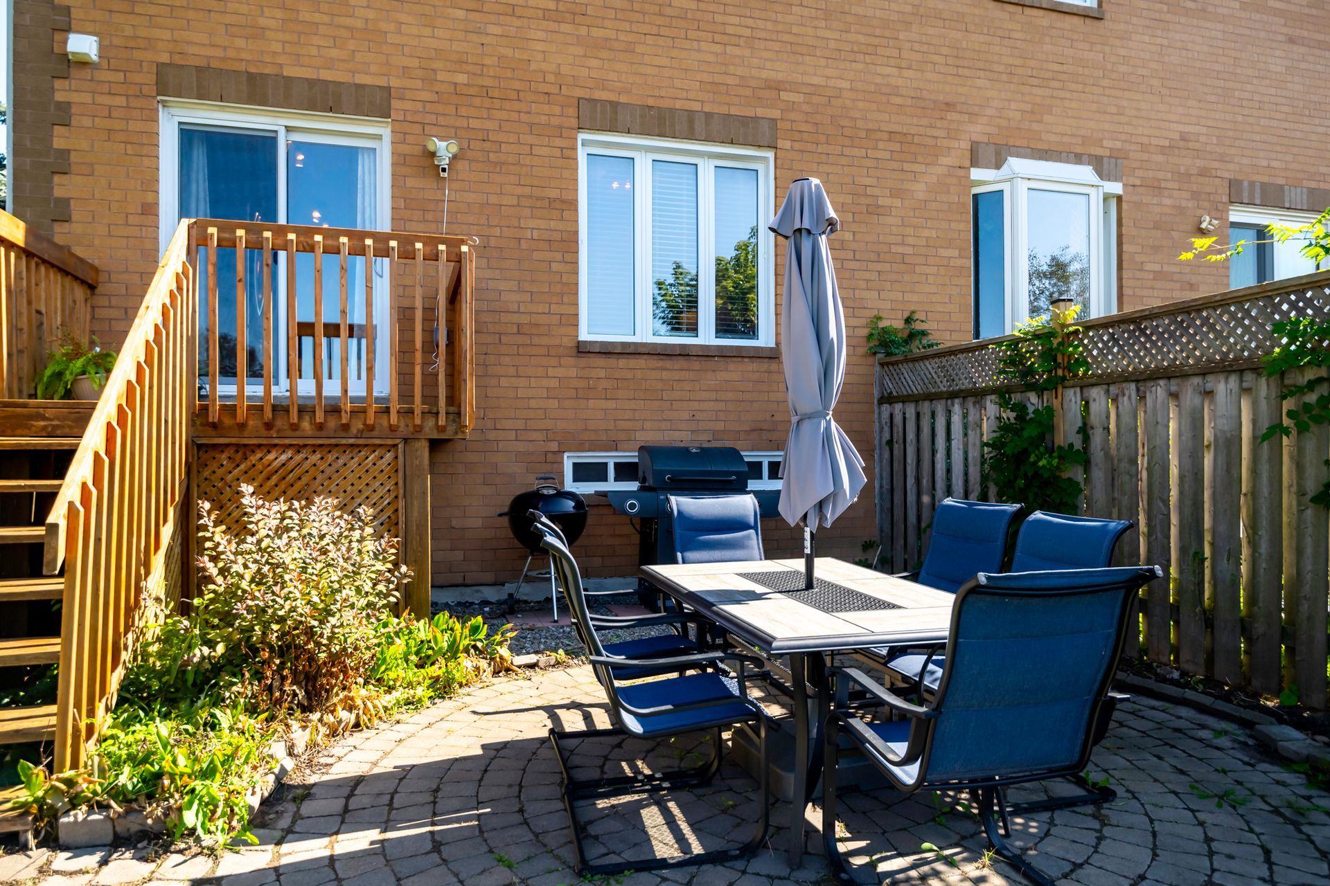 A patio with a table and chairs and an umbrella