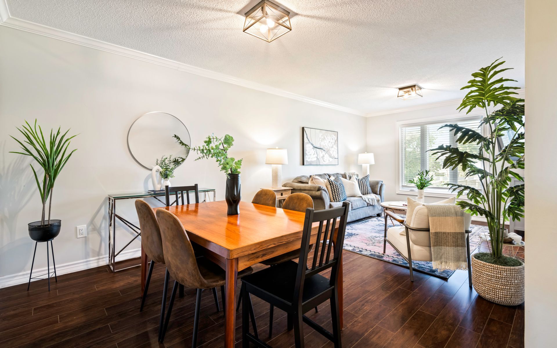 A dining room table and chairs in a living room.