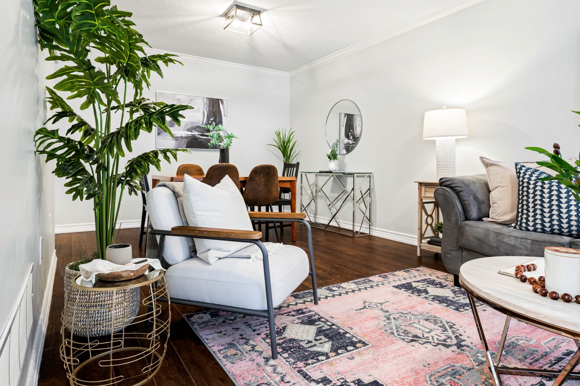 A living room with a chair , couch , table and rug.