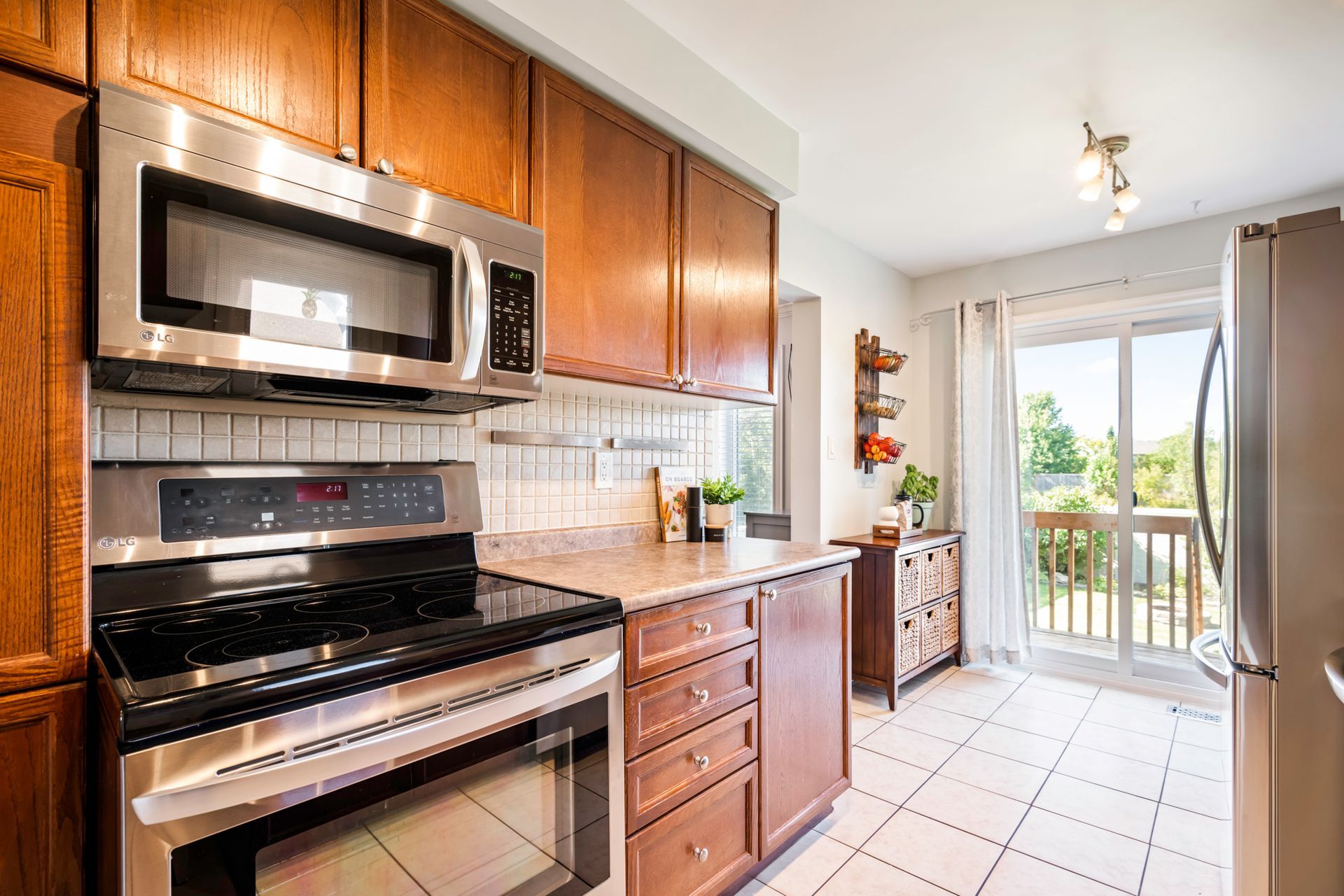 A kitchen with stainless steel appliances and wooden cabinets.