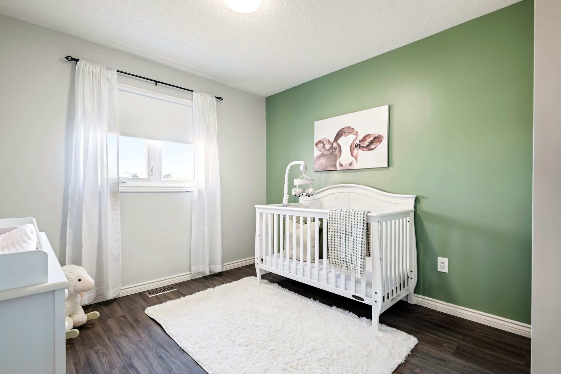 There is a crib in the middle of the room.