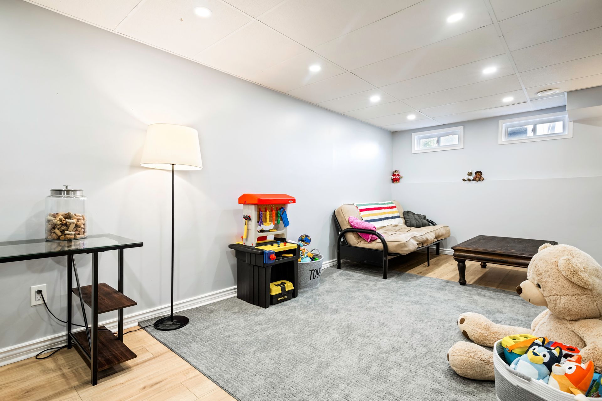 There is a teddy bear in the middle of the room.