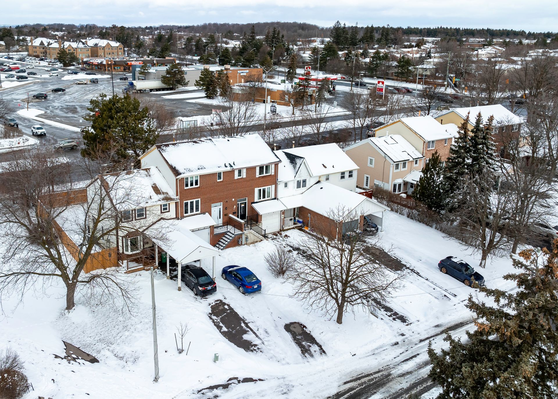 An aerial view of a residential area covered in snow.