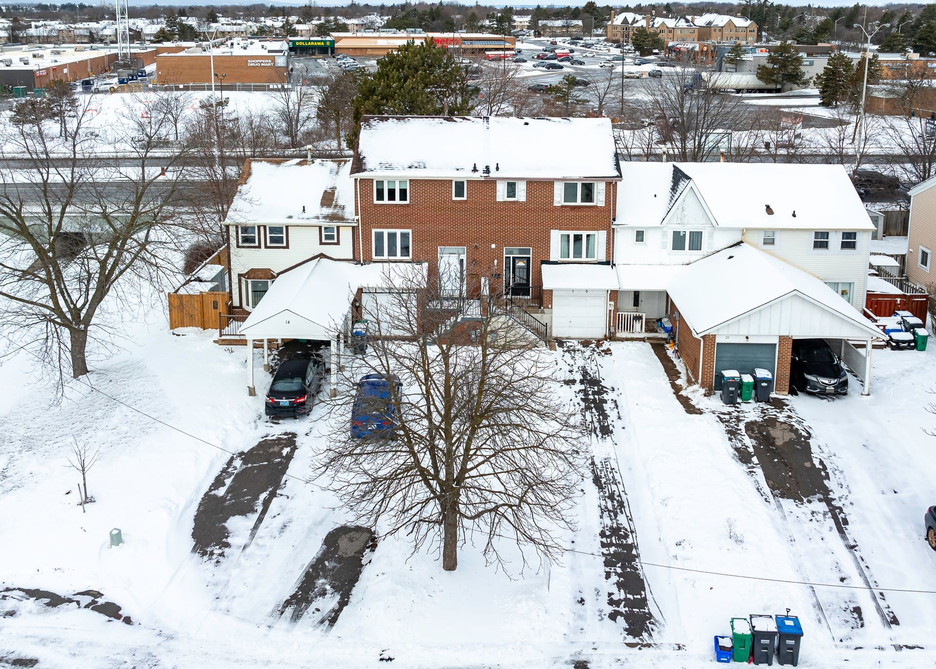 An aerial view of a residential area covered in snow.