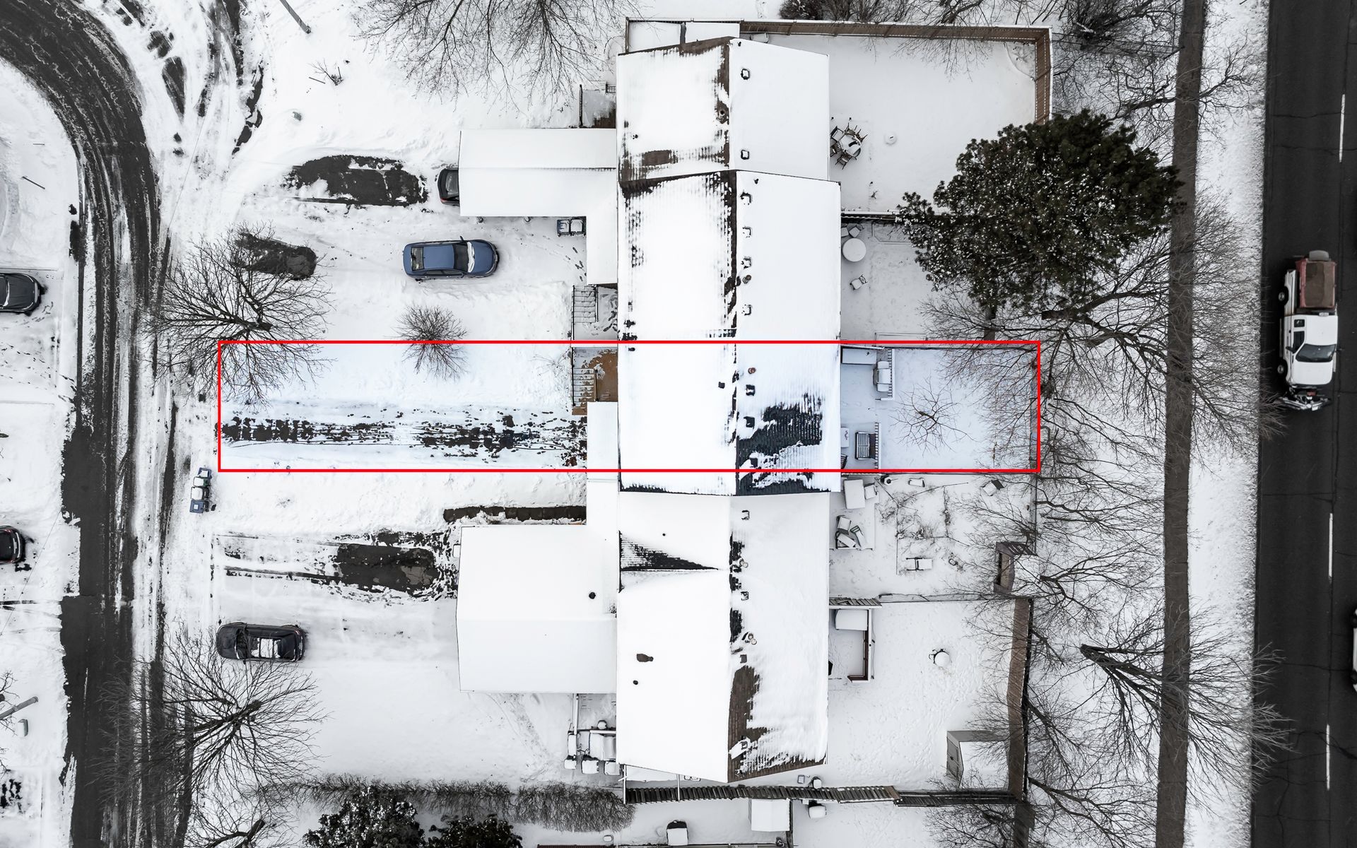 An aerial view of a house covered in snow