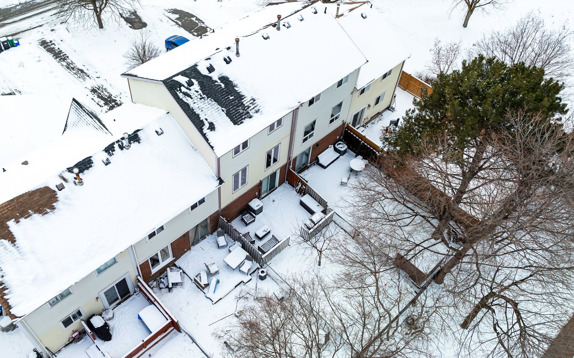 An aerial view of a house covered in snow.