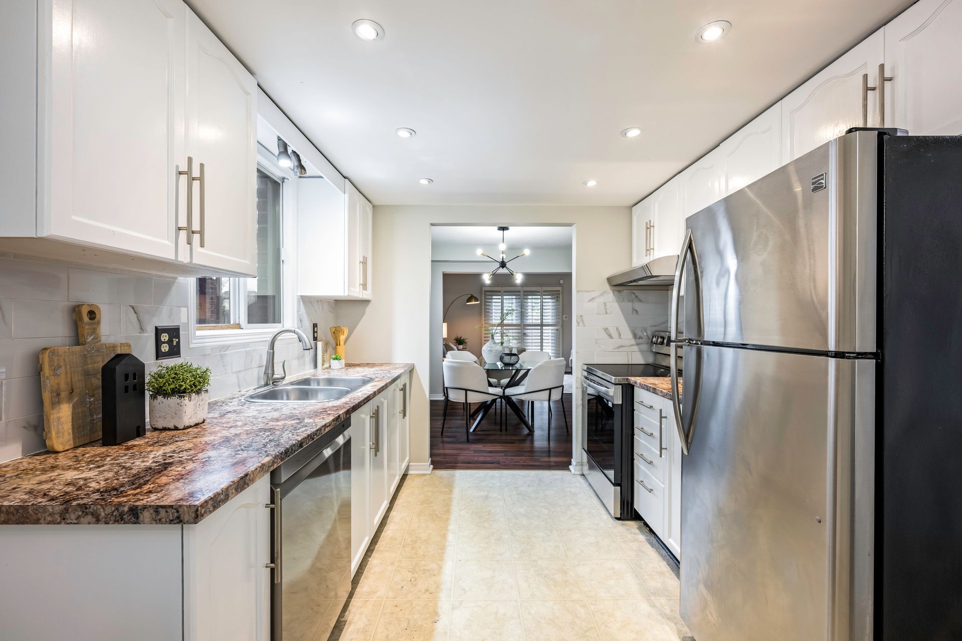 A kitchen with stainless steel appliances and granite counter tops.
