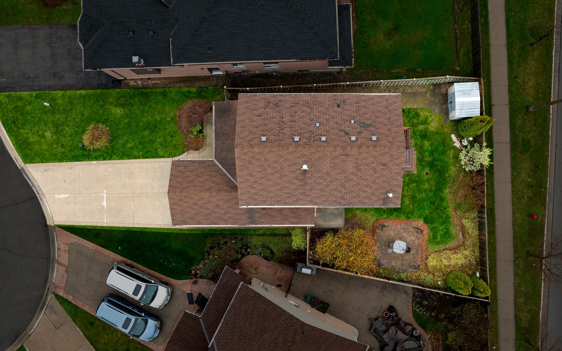 An aerial view of a house with a lot of cars parked in front of it.