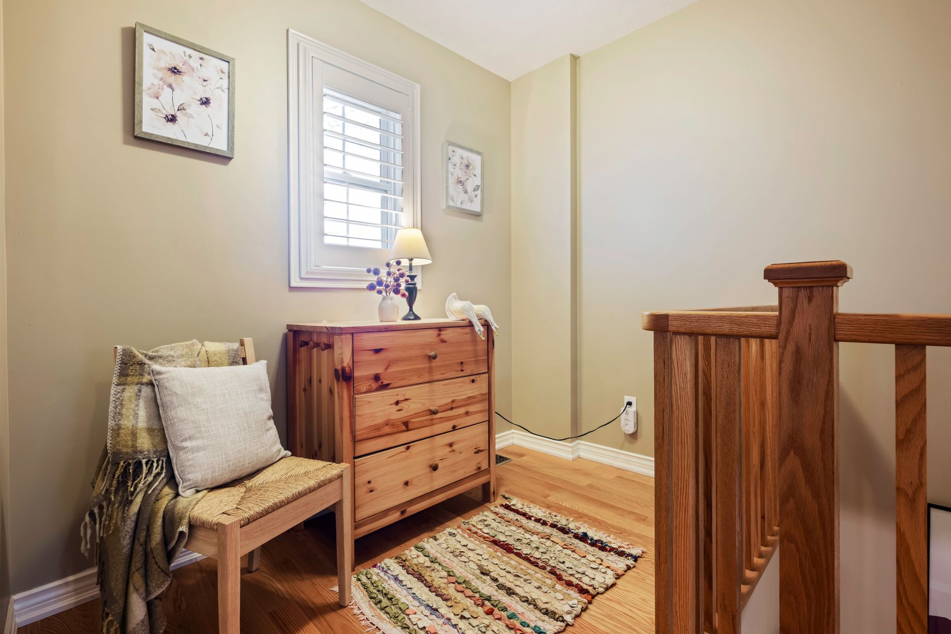 There is a dresser and a chair in the room.