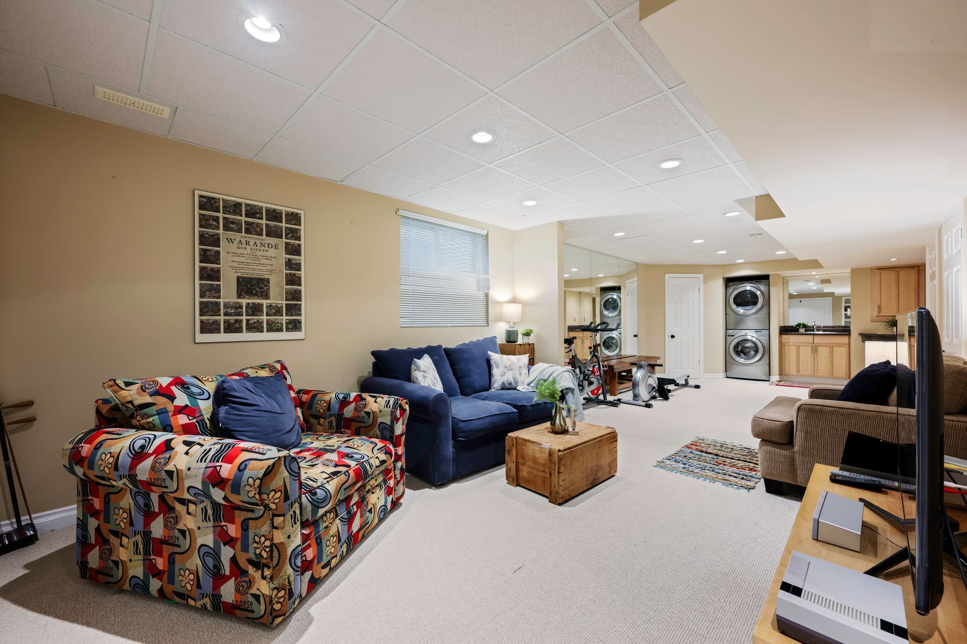A living room with a couch , chair , table and television.