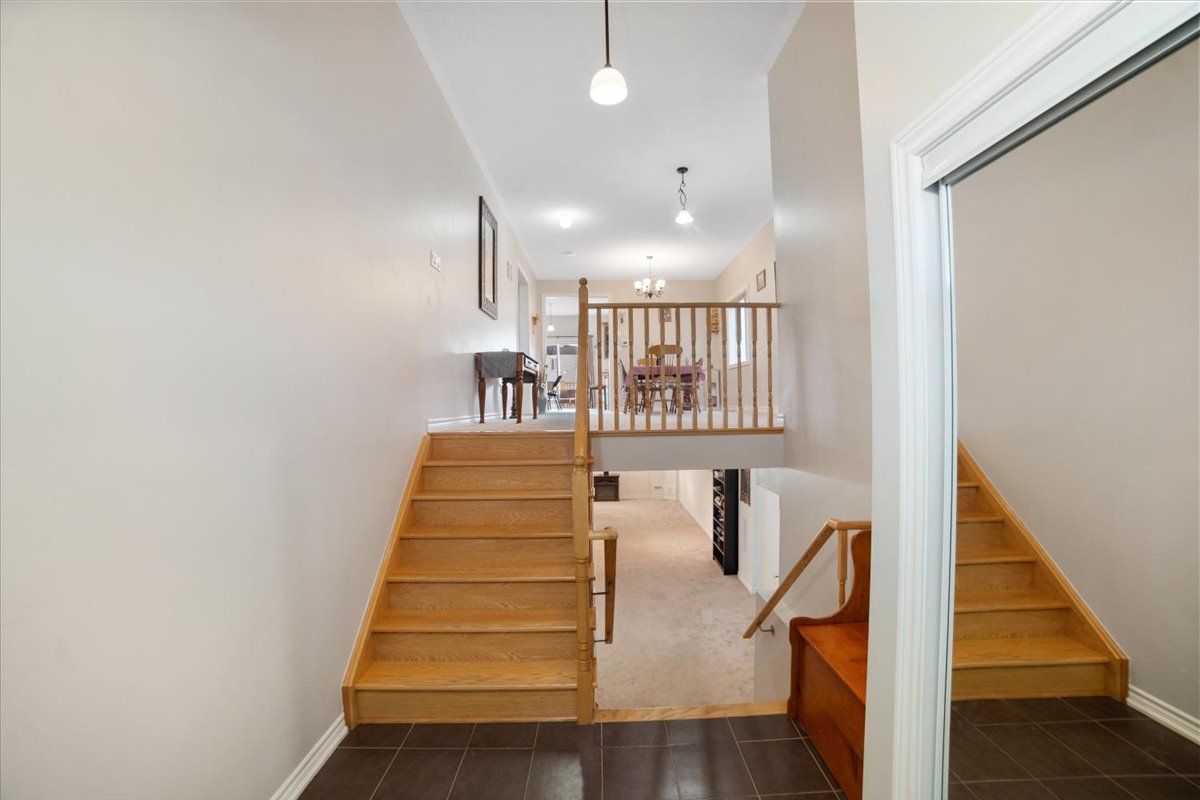 A hallway with stairs leading up to the second floor of a house.