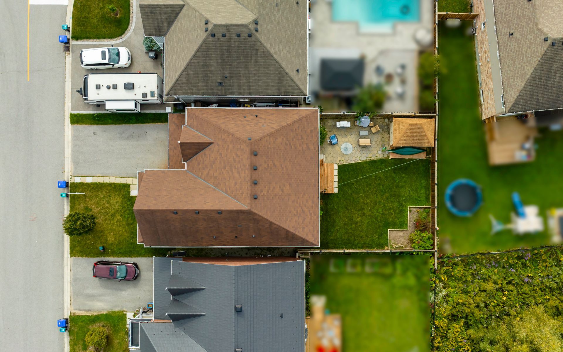 An aerial view of a residential area with houses and a pool.