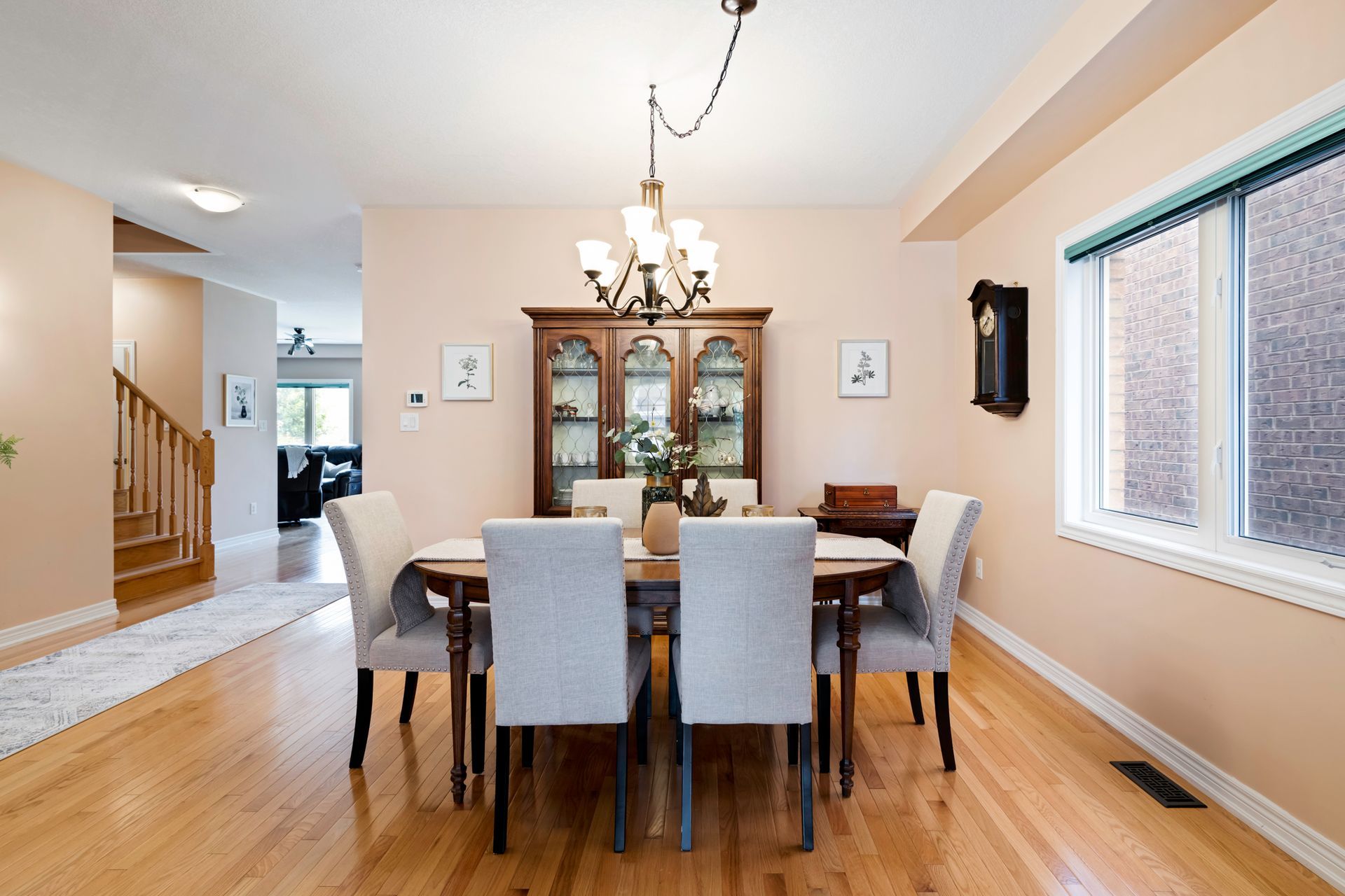 A dining room with a table and chairs and a chandelier