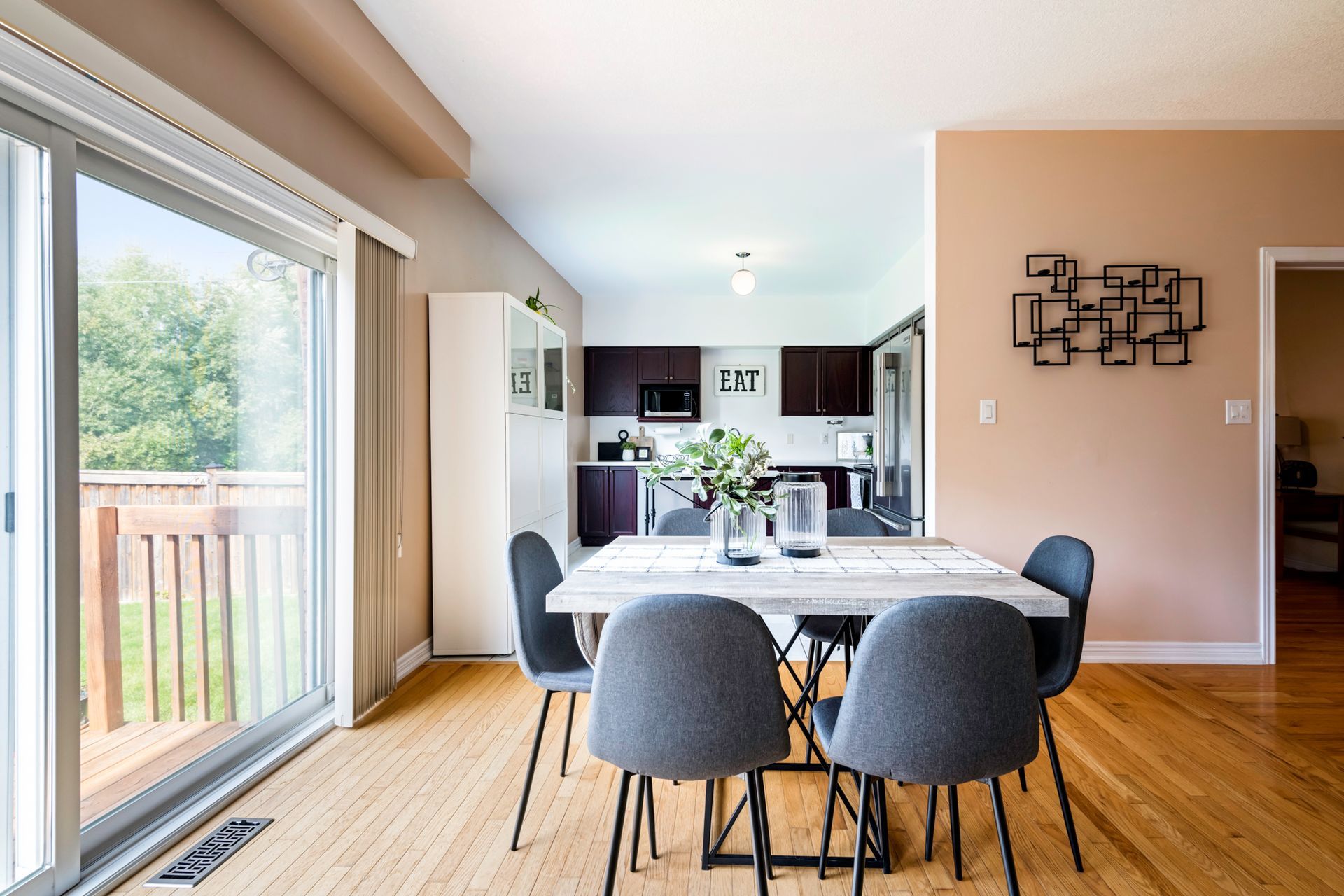 A dining room with a table and chairs and a sliding glass door