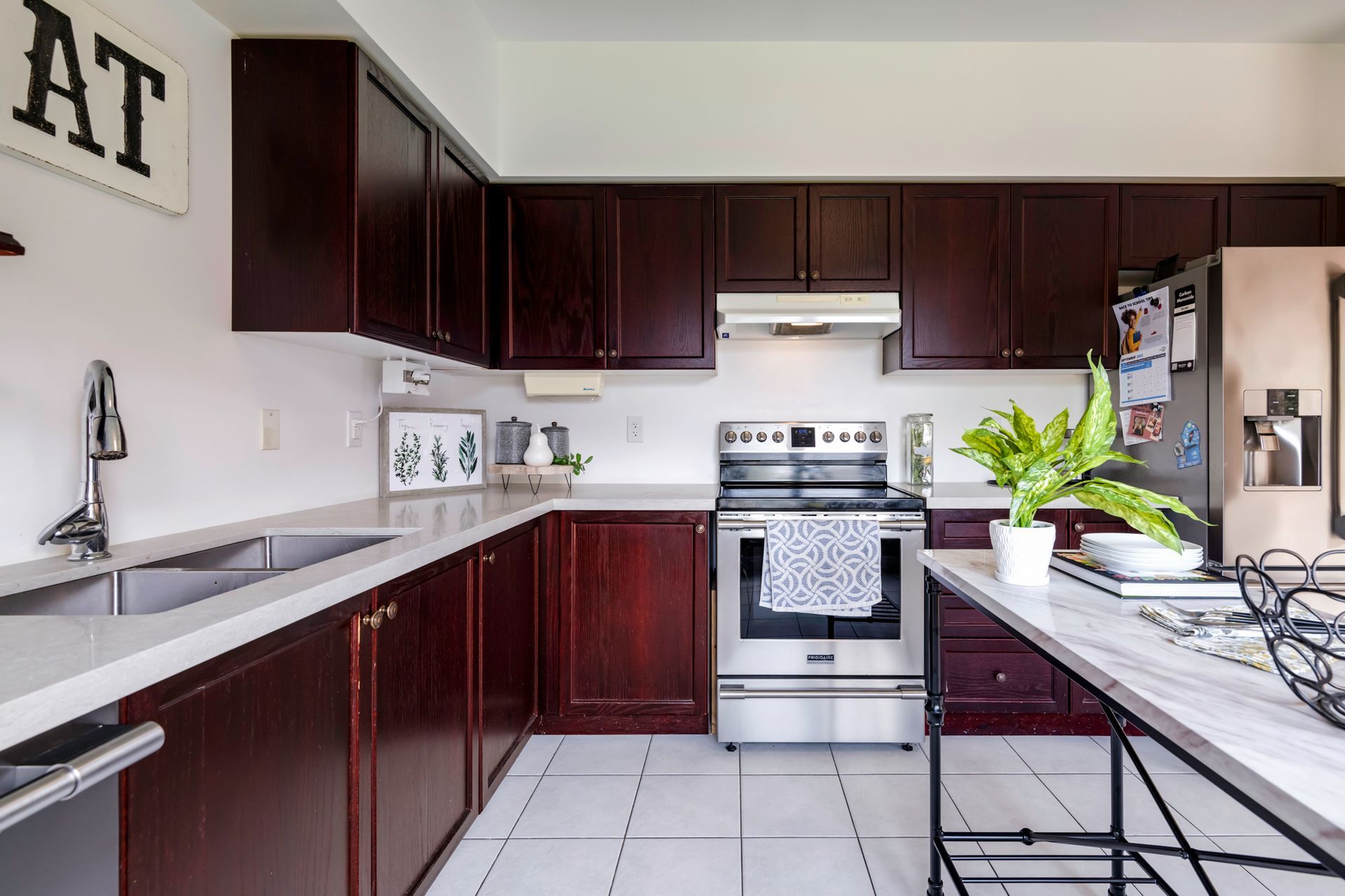 A kitchen with a sign that says at on the wall