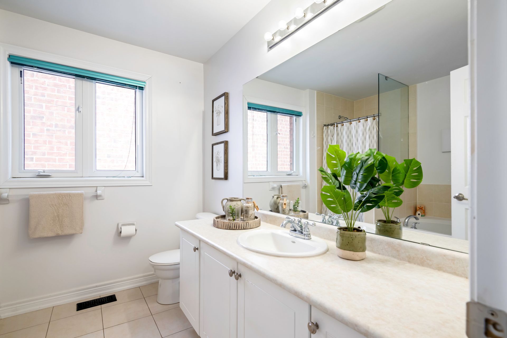 A bathroom with a sink , toilet , and mirror.