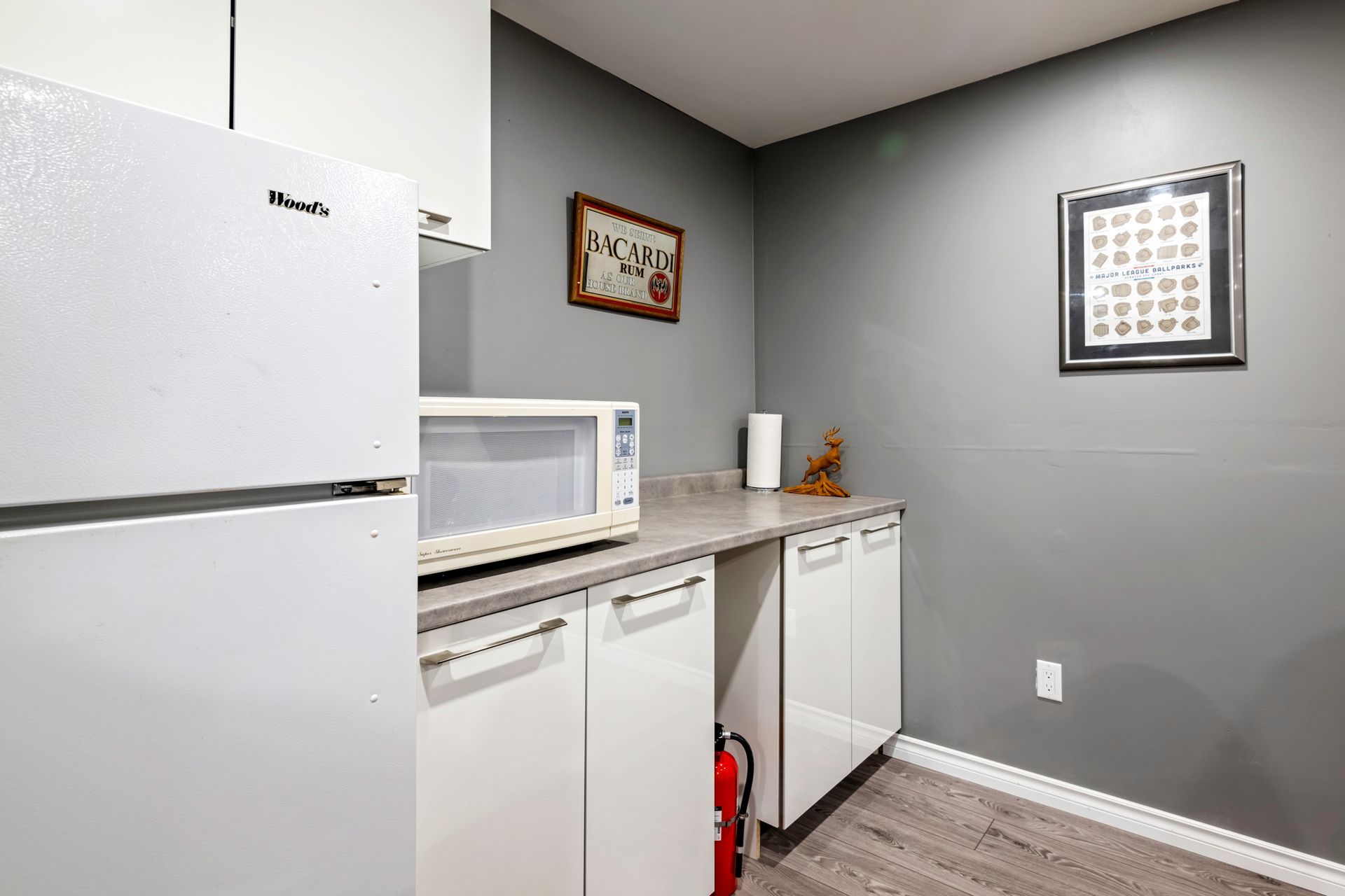 A kitchen with a refrigerator , microwave , and dishwasher.