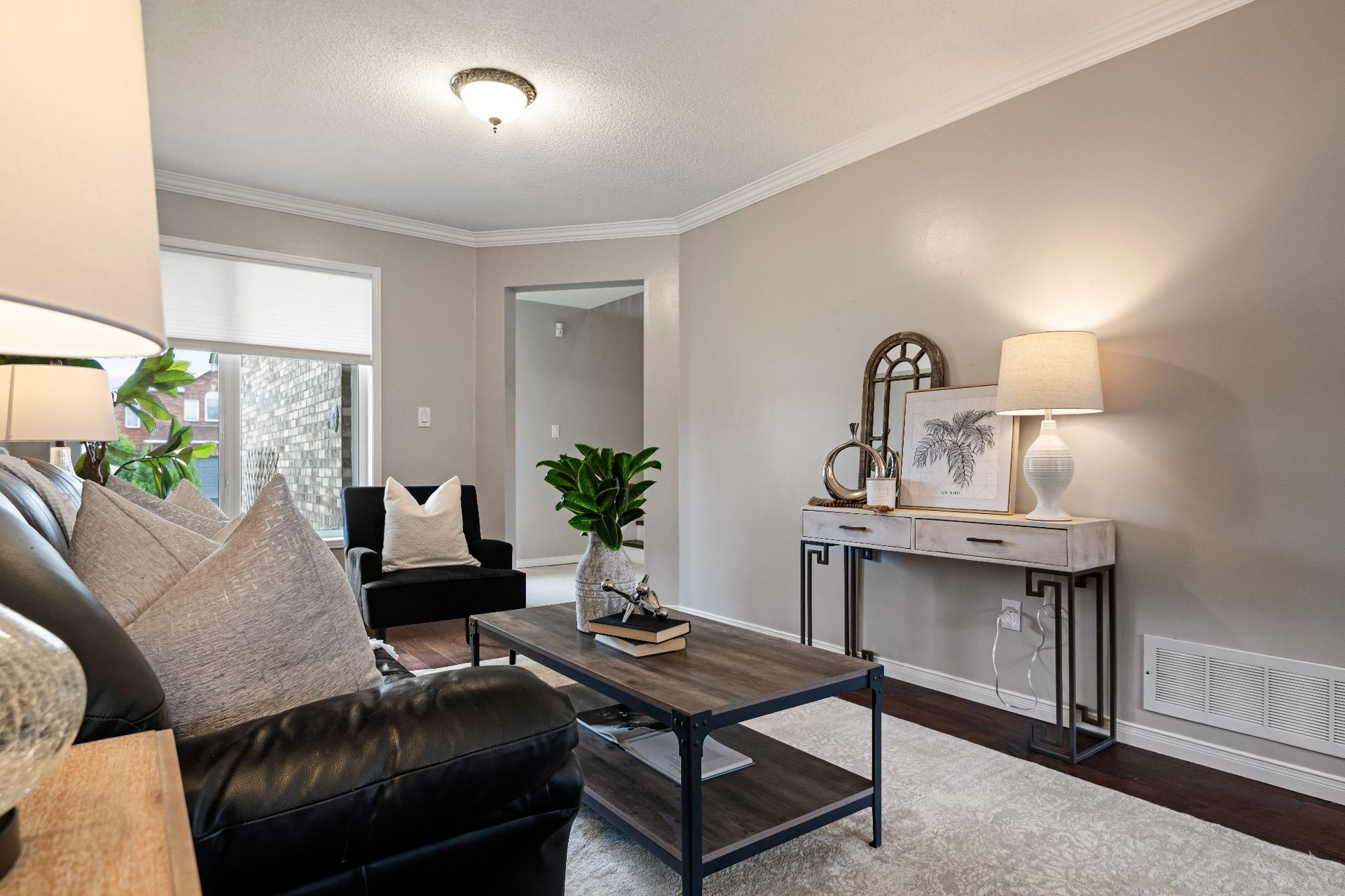 A living room with a couch , coffee table , and lamps.