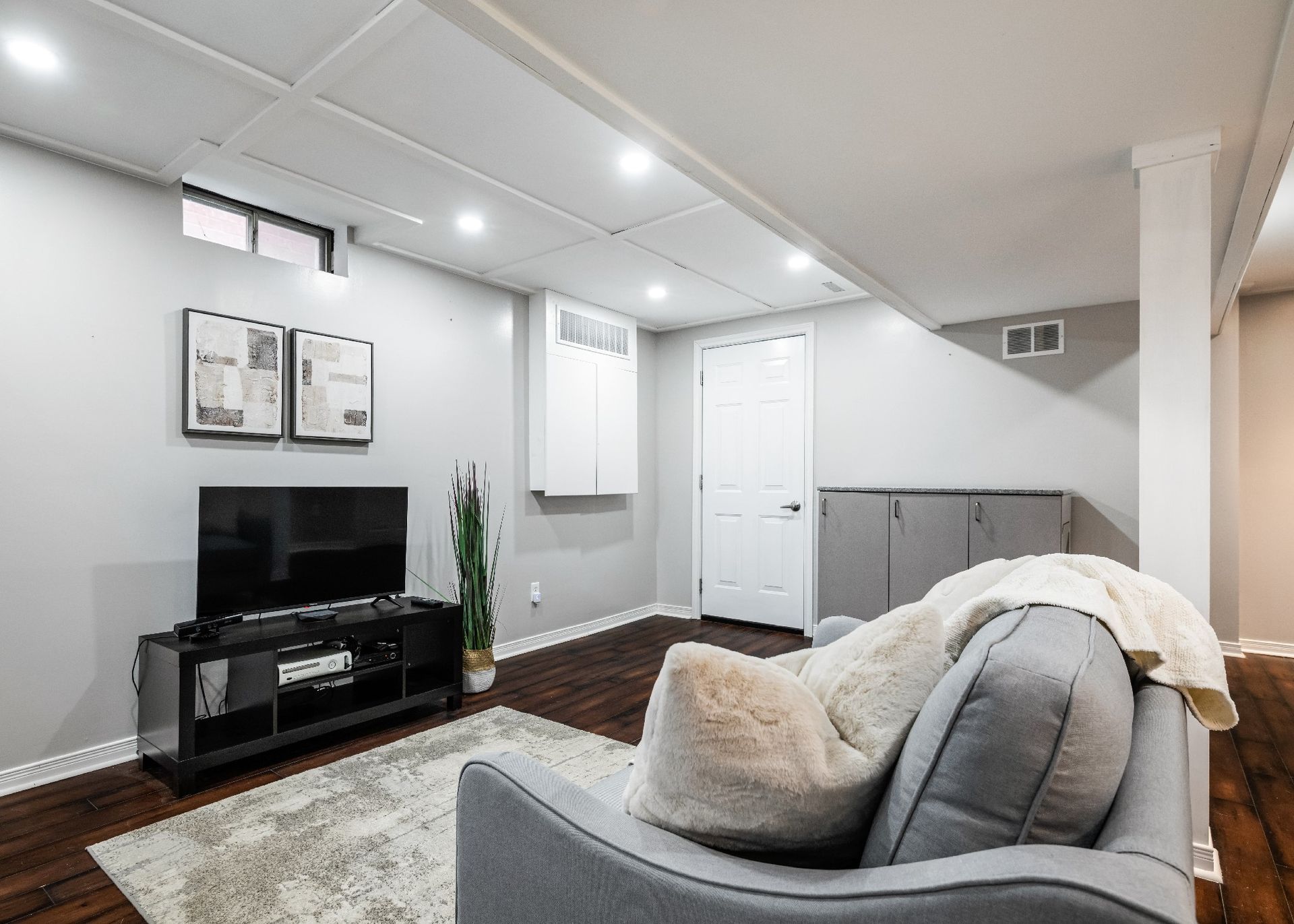 A living room with a couch , television , and rug.
