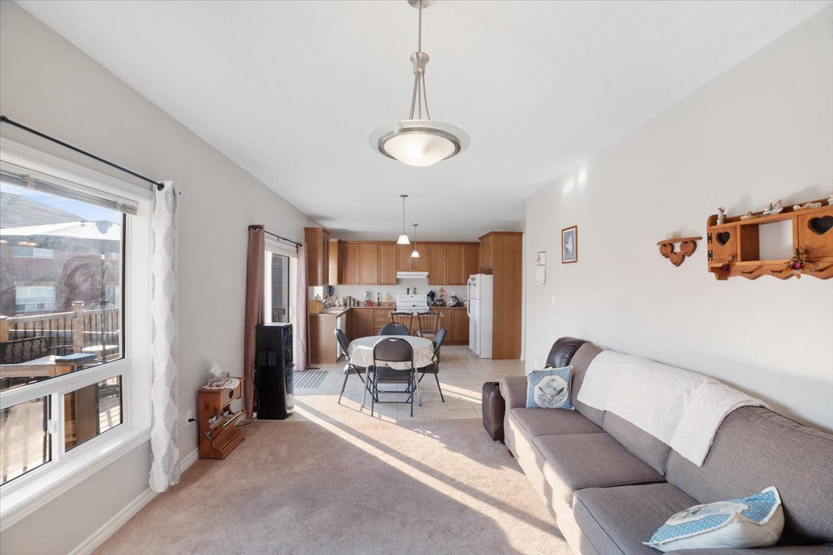 A living room with a couch and a kitchen in the background