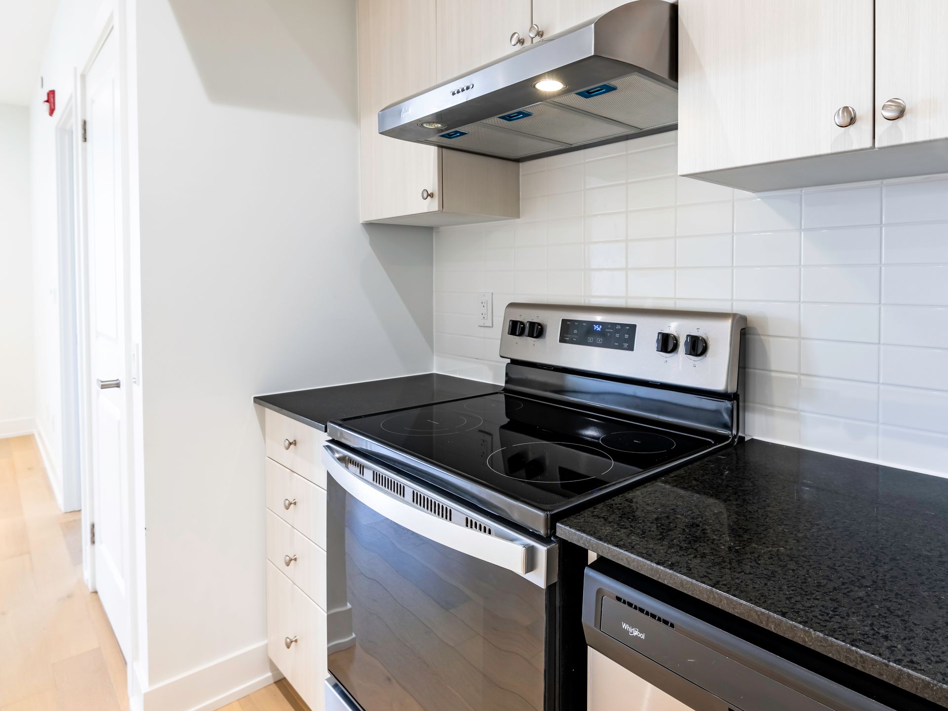 A kitchen with a stove top oven and a dishwasher.