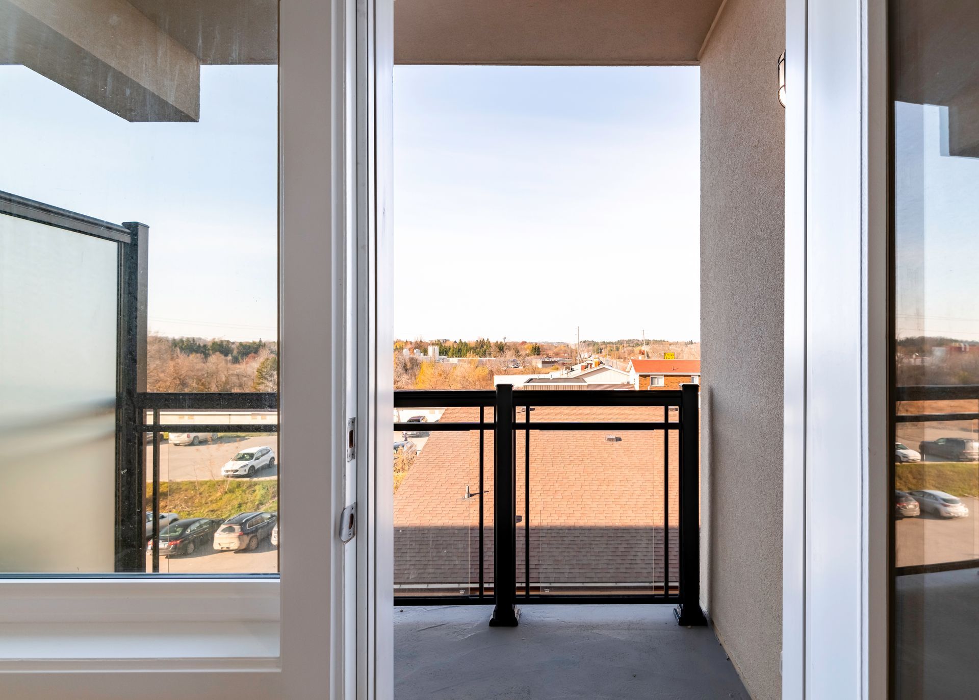 A balcony with a sliding glass door leading to it