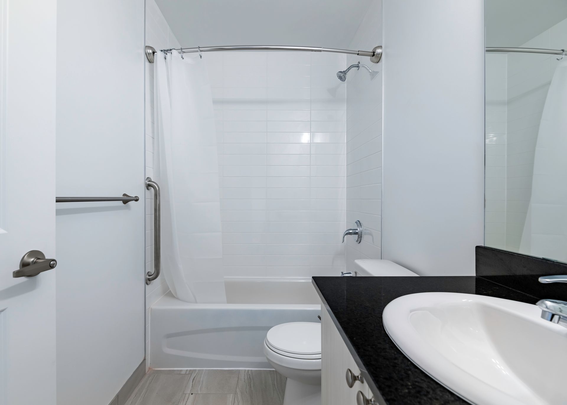 A bathroom with a sink , toilet , bathtub and shower.