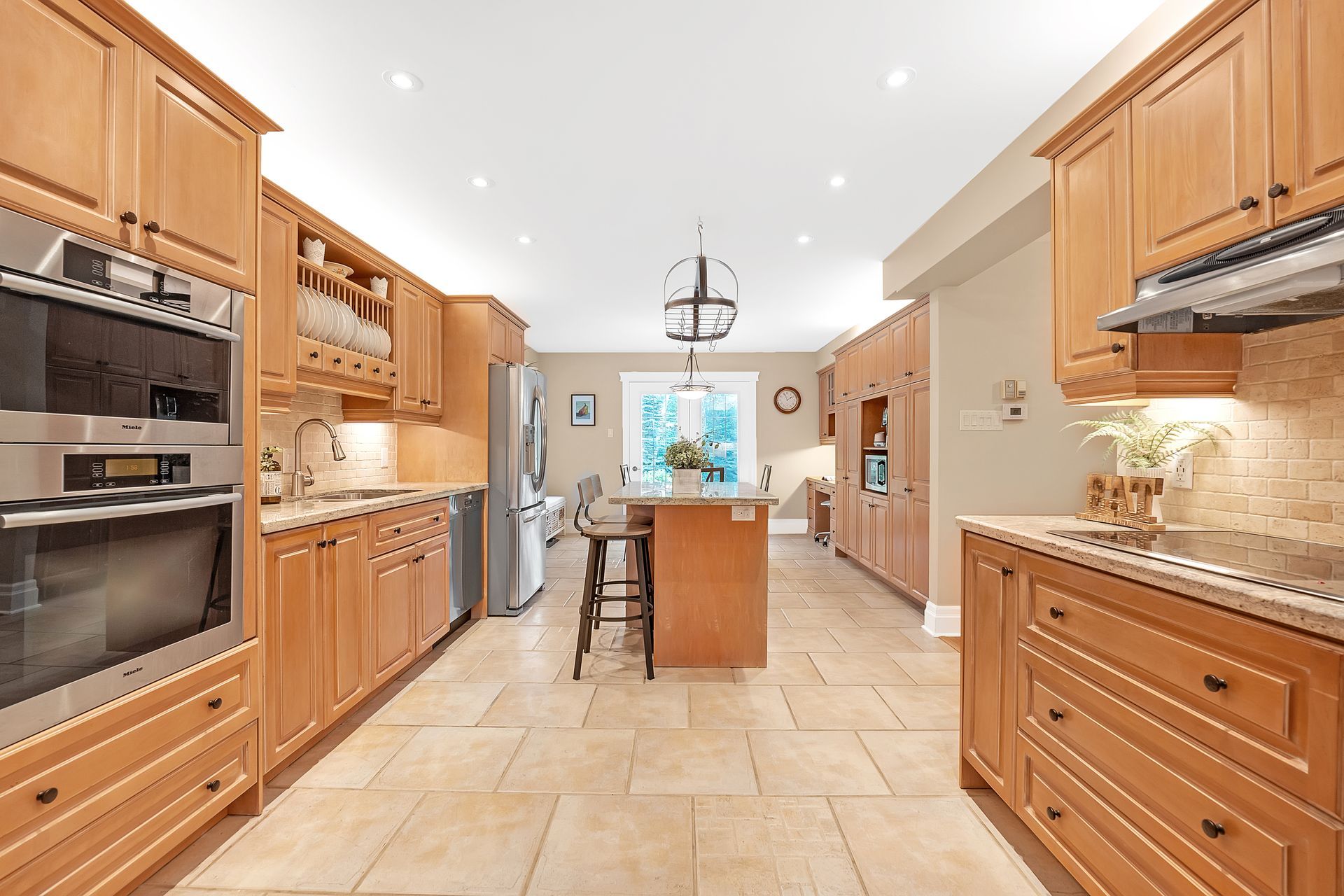 A large kitchen with wooden cabinets and stainless steel appliances