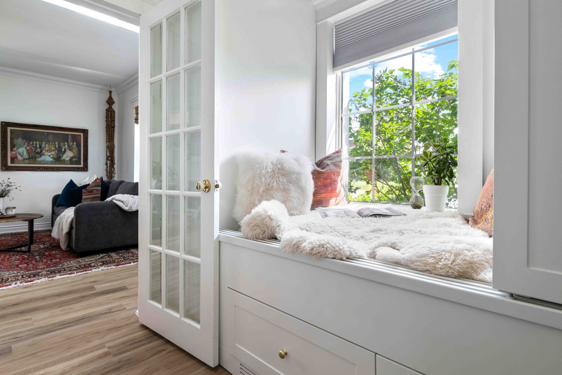 A living room with a window seat and a couch.