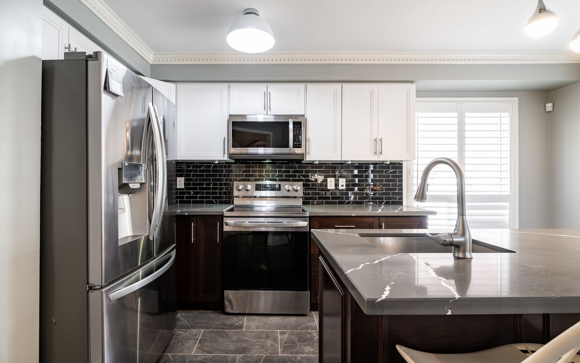A kitchen with stainless steel appliances and white cabinets
