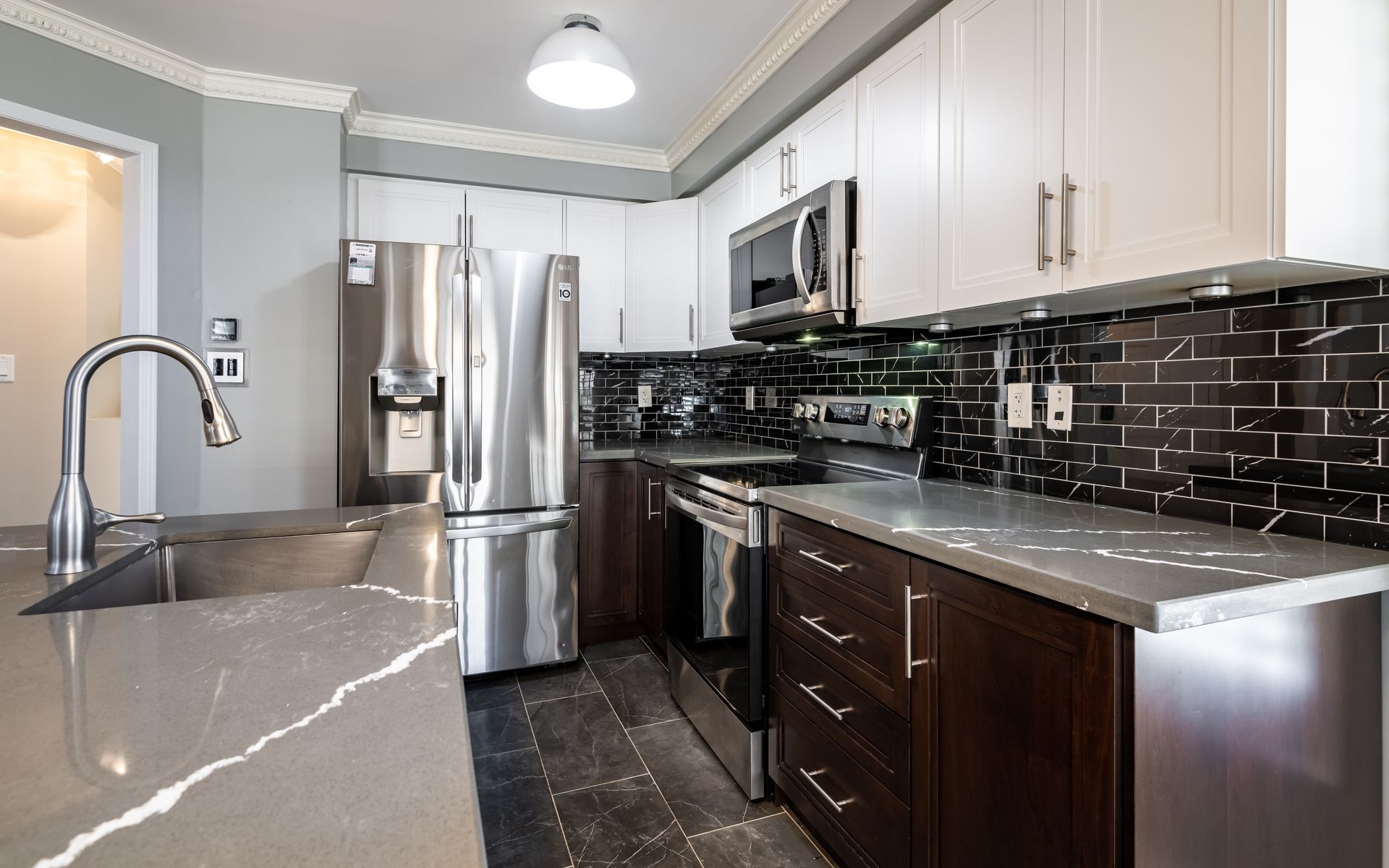A kitchen with stainless steel appliances and granite counter tops.