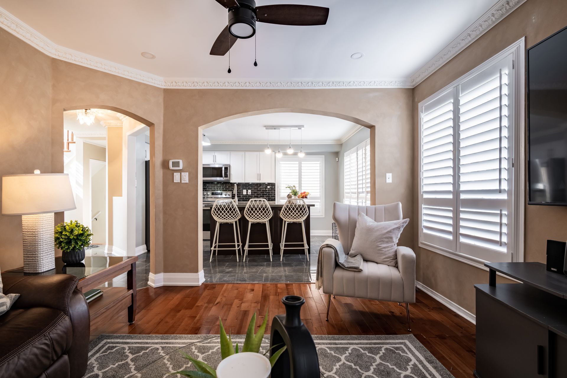 A living room filled with furniture and a ceiling fan.