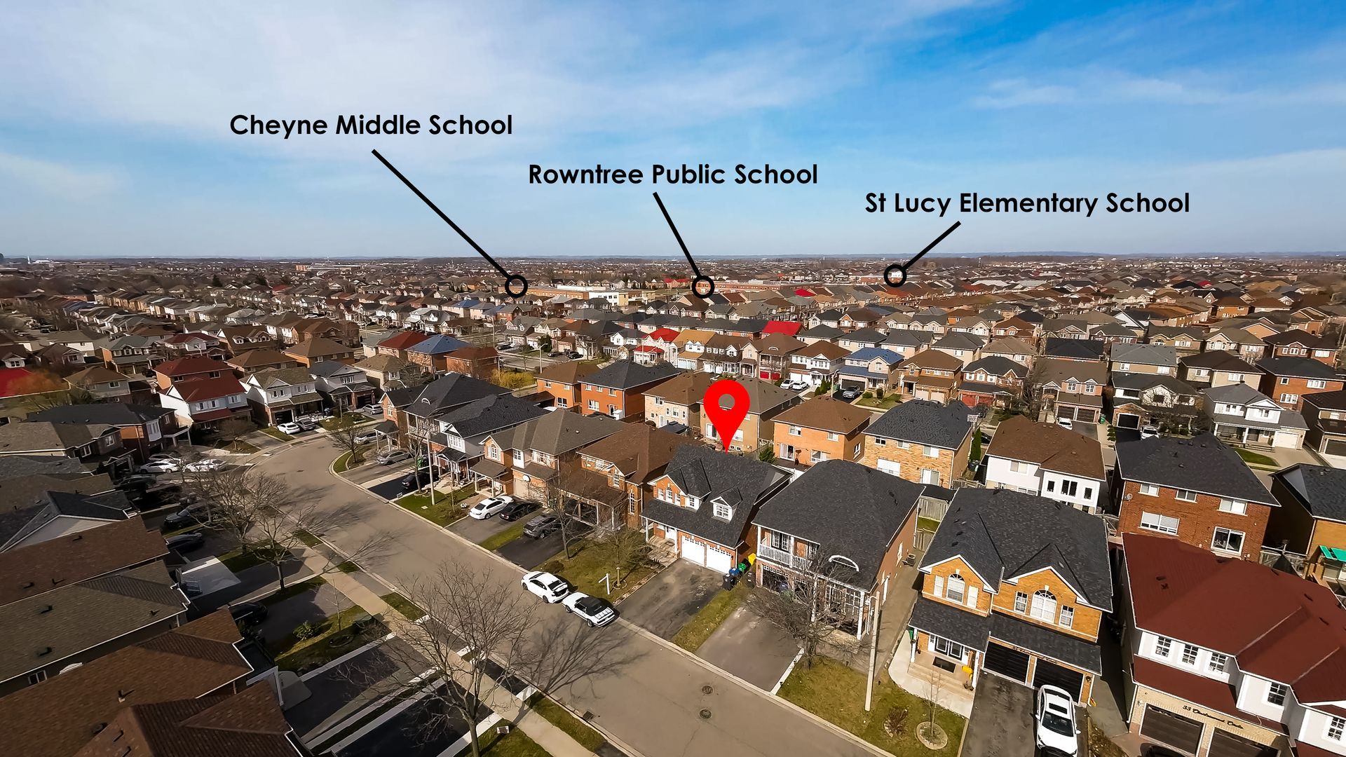 An aerial view of a residential area with a school in the middle