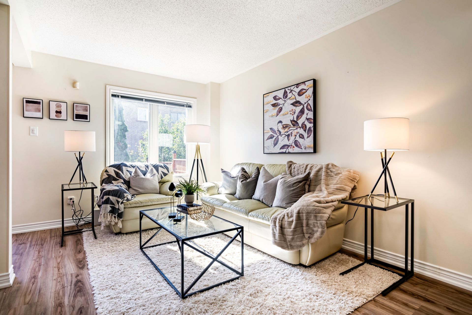 A living room with a couch , coffee table , and lamps.