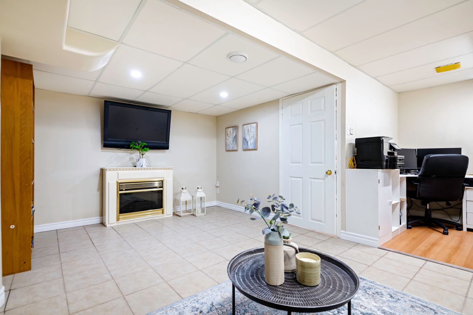 A living room with a fireplace and a flat screen tv.