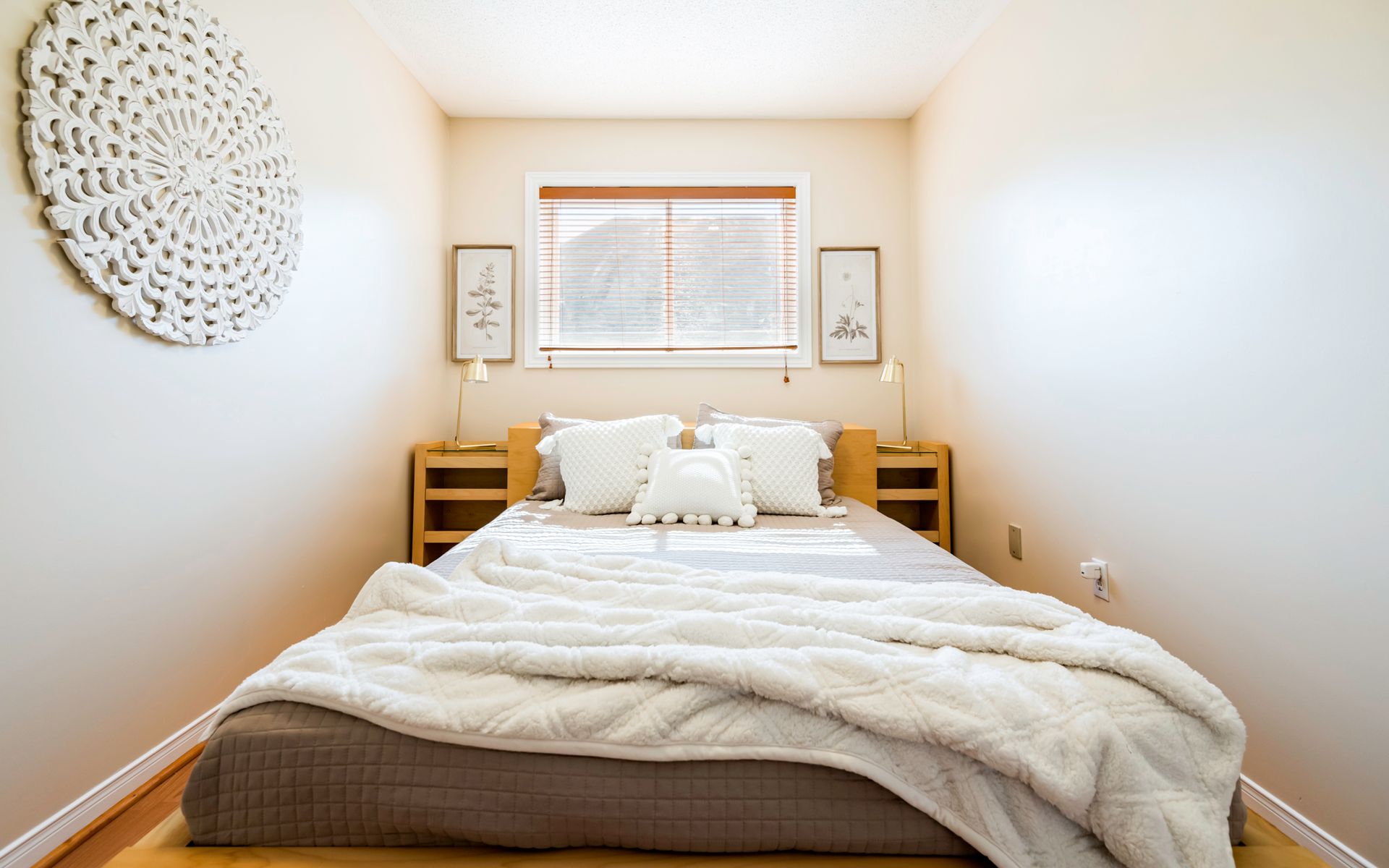 A bedroom with a bed , nightstands , and a window.