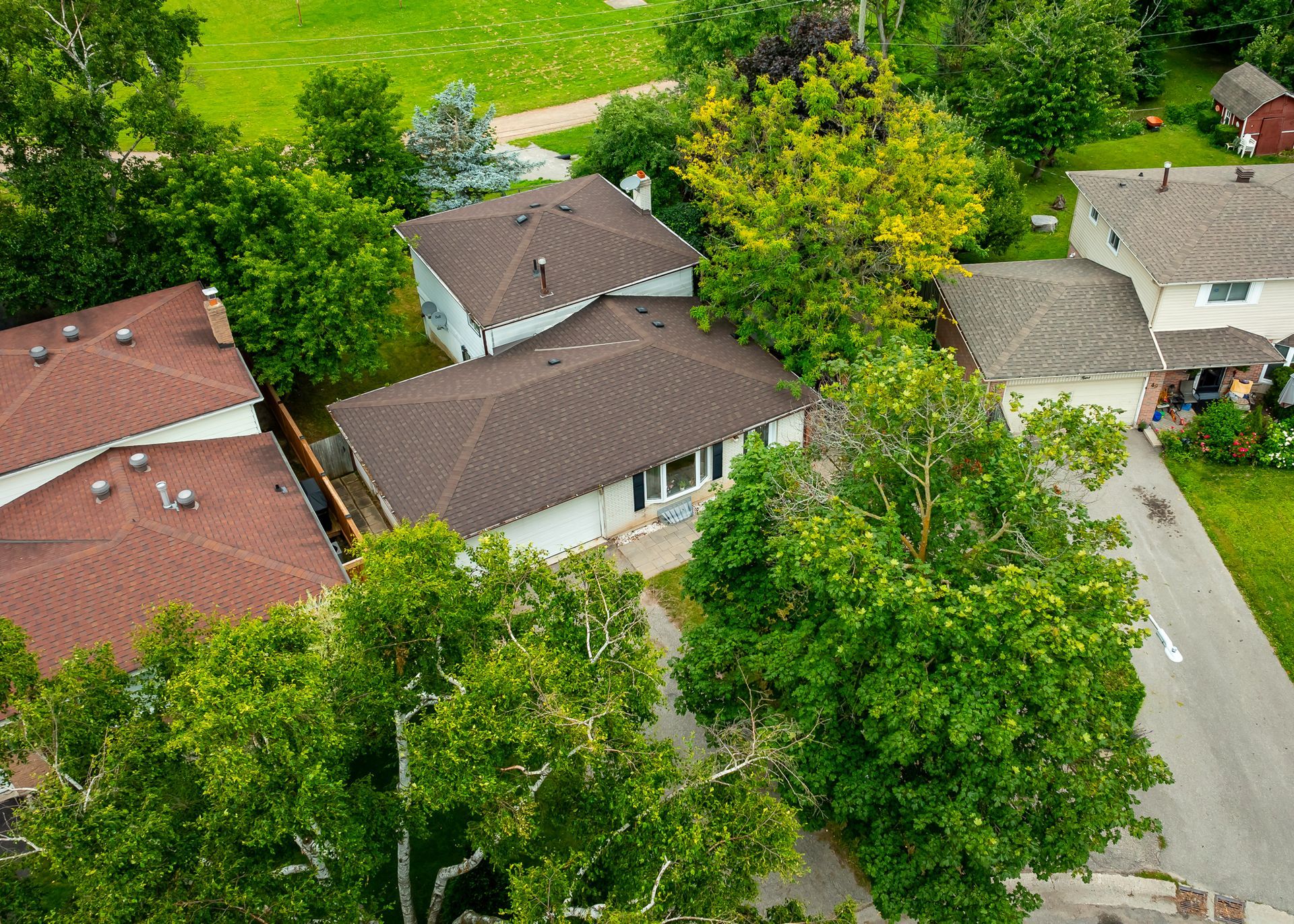 An aerial view of a residential area with houses and trees