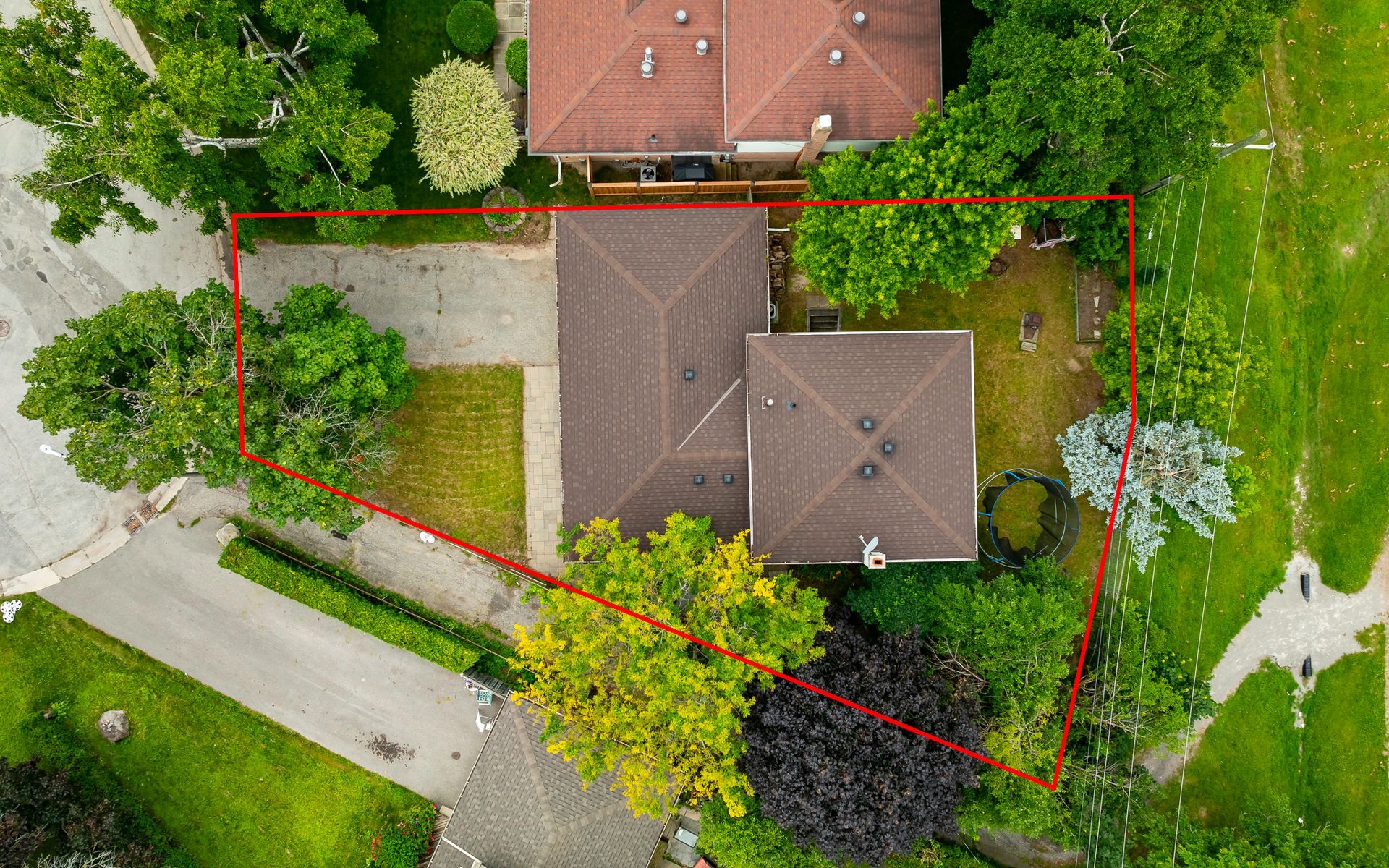 An aerial view of a house with a red line around it.