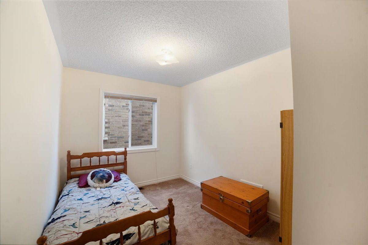 A bedroom with a bed and a trunk in it