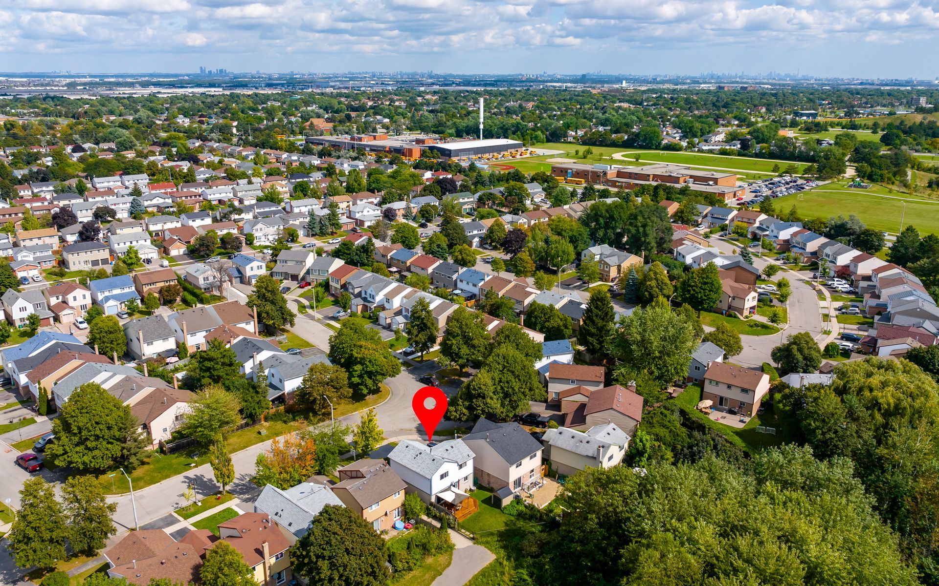An aerial view of a residential area with houses and trees.