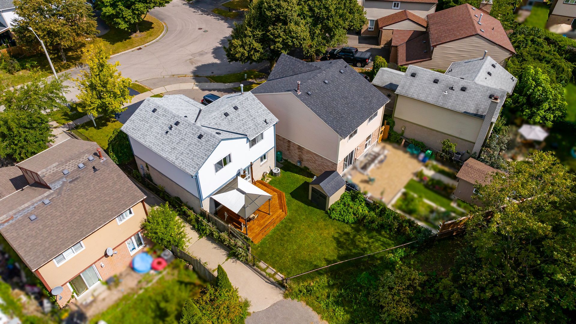 An aerial view of a residential area with houses and trees.